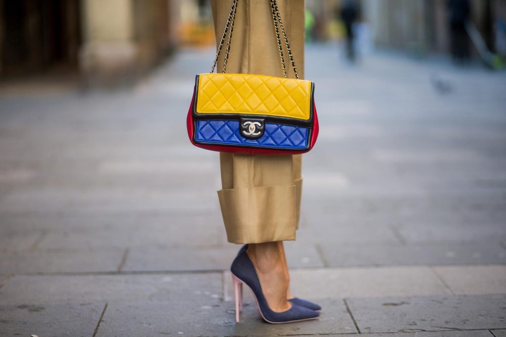 BARCELONA, SPAIN - NOVEMBER 27: Alexandra Lapp wearing Safari look, wide cut khaki pants from Steffen Schraut, khaki jacket with blue collar and blue and white strips on the bottom of the sleeve from Steffen Schraut, denim shirt by Steffen Schraut, So Kate Pumps from Christian Louboutin in denim, Chanel 2.55 bag in red, blue and yellow with golden logo buckle on November 27, 2017 in Barcelona, Spain.