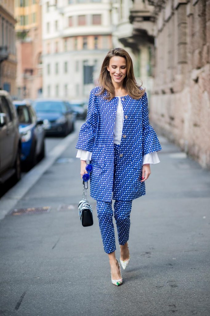 MILAN, ITALY - FEBRUARY 21: Alexandra Lapp wearing dots and stripes, blue trousers with white dots and a matching jacket with a wider short sleeve and a long white blouse from Steffen Schraut, Aigner bag, white pumps from Christian Louboutin seen during Milan Fashion Week Fall/Winter 2018/19 on February 21, 2018 in Milan, Italy.