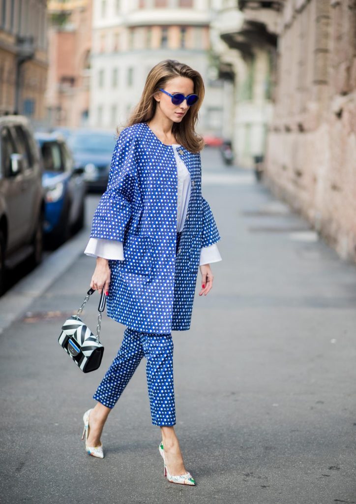 MILAN, ITALY - FEBRUARY 21: Alexandra Lapp wearing dots and stripes, blue trousers with white dots and a matching jacket with a wider short sleeve and a long white blouse from Steffen Schraut, Aigner bag, white pumps from Christian Louboutin seen during Milan Fashion Week Fall/Winter 2018/19 on February 21, 2018 in Milan, Italy.