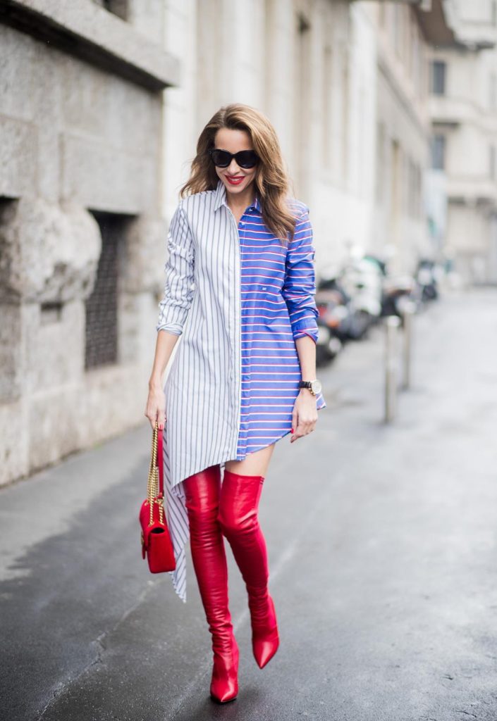Alexandra Lapp wearing an asymmetric striped blouse by Off-white, red leather over knee boots from Fendi, a red velvet Gucci Marmont handbag with a golden chain and black sunglasses from Celine seen during Milan Fashion Week Fall/Winter 2018/19 on February 24, 2018 in Milan, Italy.