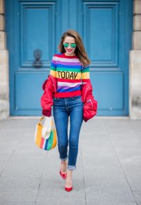 PARIS, FRANCE - FEBRUARY 28: Alexandra Lapp wearing Pullover Alberta Ferretti with today print, AG Jeans denim, Bag MCM Patricia Hobo bag in striped Canvas, Aviator Sunglasses in green from Ray Ban, Heels Gianvito Rossi in patent red, jacket Yves Salomon is seen on February 28, 2018 in Paris, France.