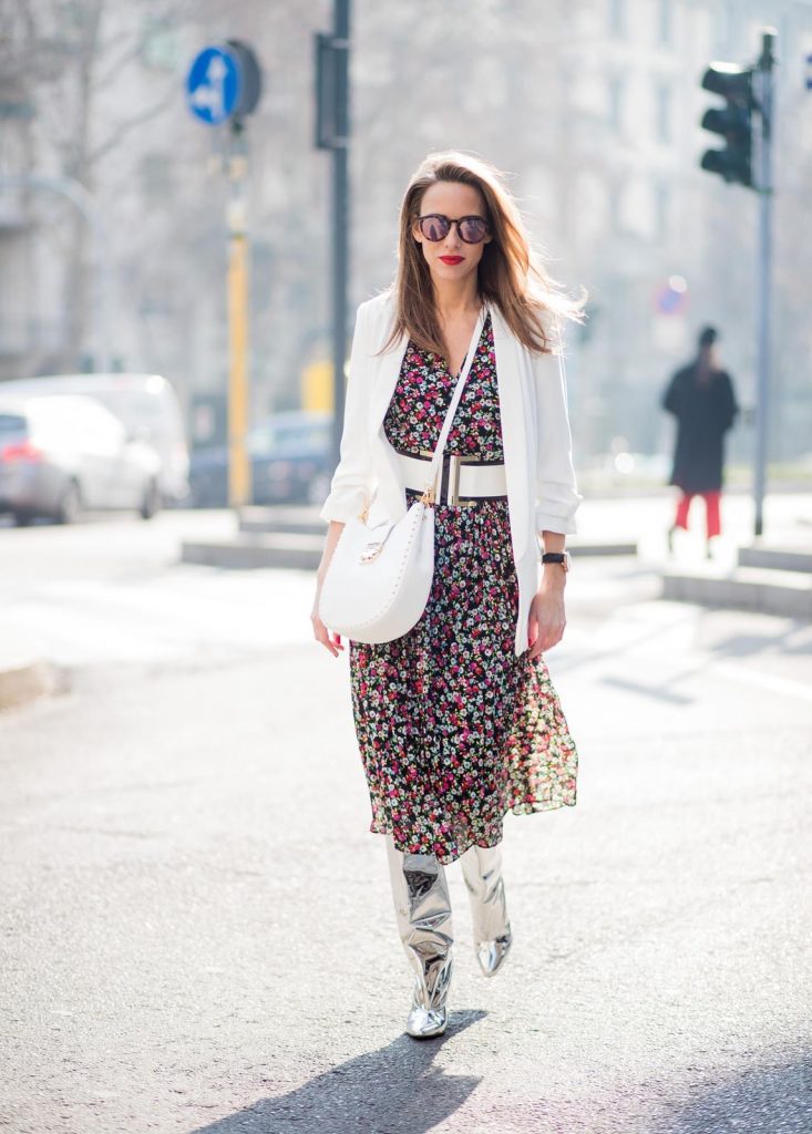 Alexandra Lapp wearing a long flower dress from H&M, silver shiny boots by H&M, a long white blazer from Zara, a lacquer waist belt in white and black from Balmain, a white Patricia Hobo bag with studs and sunglasses from Le Specs in pink seen during Milan Fashion Week Fall/Winter 2018/19 on February 21, 2018 in Milan, Italy.