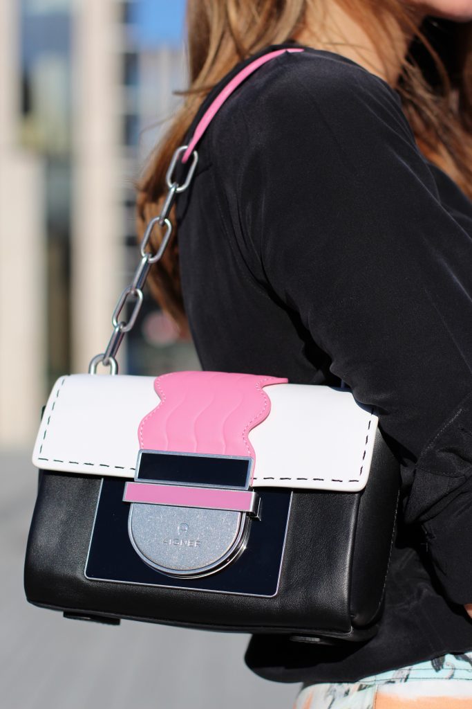 #AIGNERLOVE - DUESSELDORF, May 2018, Model and Blogger Alexandra Lapp wearing the it-bag Aigner Candice bag S in pink with black and white combined with the Love shoulder strap.