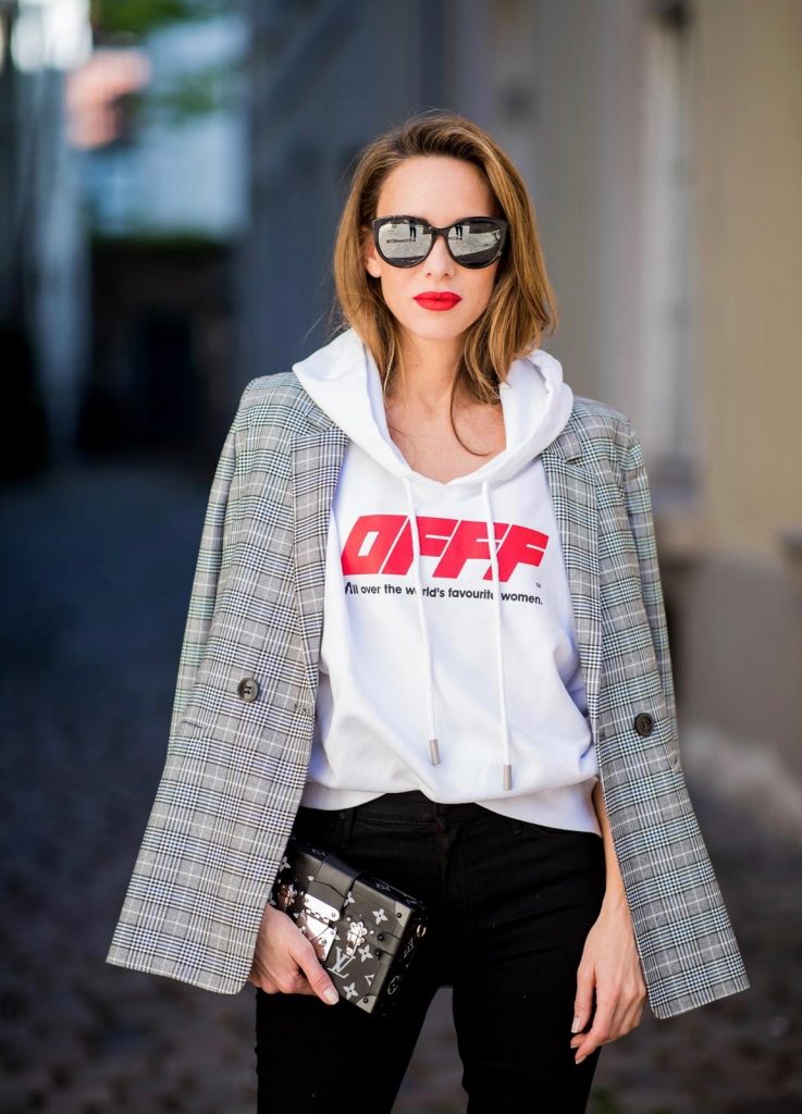 Alexandra Lapp wearing the Off-White Hoodie c/o Virgil Abloh 0777 cotton Terry Hoodie in white, multicolored plaid Madeleine blazer by Anine Bing, the Cha Cha Fray flared pants in black by Mother, black patent leather pumps by Christian Louboutin, a black Petite Malle with silver accessories by Louis Vuitton and black Diormania sunglasses by Dior on May 6, 2018 in Duesseldorf, Germany.