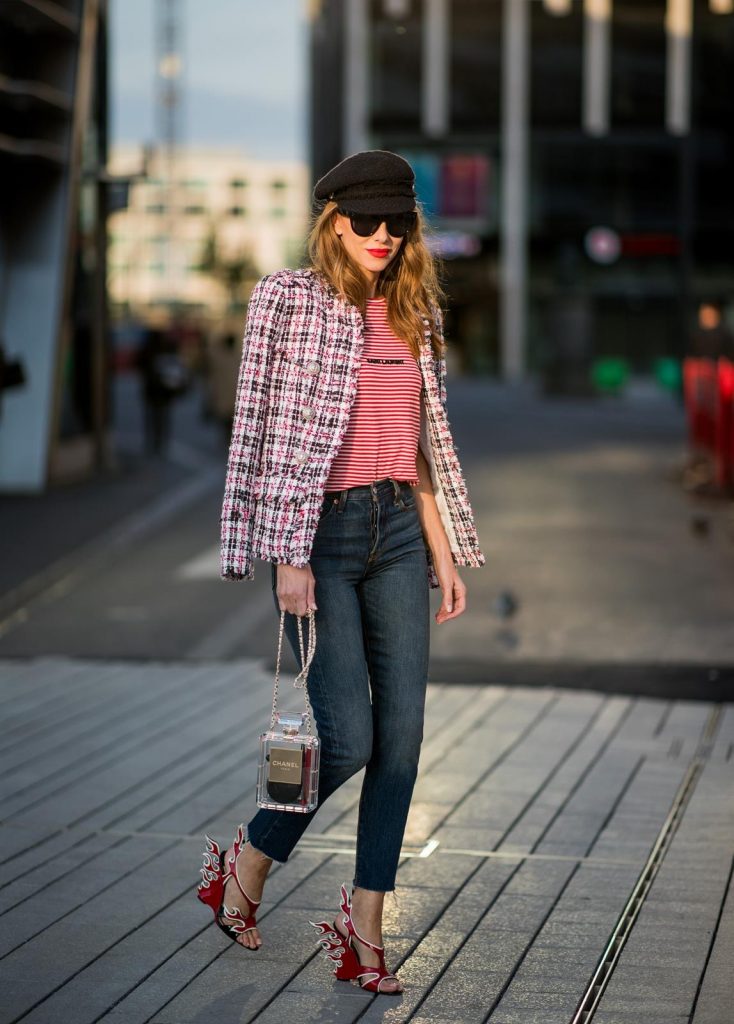 Alexandra Lapp wearing a striped shirt look with Saint Laurent Logo jersey T-Shirt in red-white, a white/blue/red Tweed Jacket by Balmain, dark blue Levis Super Skinny jeans, Prada flame shoes, the Chanel Perfume Bottle Bag in clear plexiglass, vintage Chanel Bakerboy cap and black Celine sunglasses on May 3, 2018 in Duesseldorf, Germany.