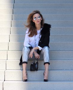 Model and Blogger Alexandra Lapp wearing silver denim pants from Airfield, black knit and fur cape from Airfield, black Boy Bag from Chanel, Chanel vintage necklace, silver sunglasses by Le Specs, white silk shirt from Jades and black lacquer Pigalle pumps from Christian Louboutin.