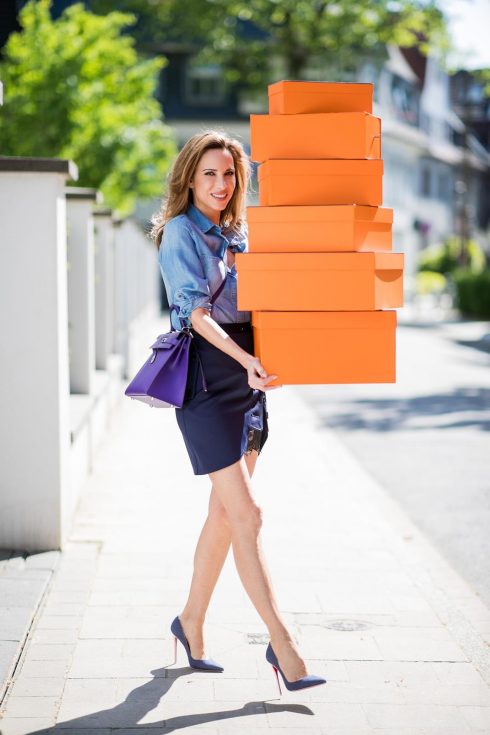 Alexandra Lapp in Hermès Addiction wearing a blue satin skirt with lace by Self-Portrait, a light blue denim shirt by H&M, a purple Kelly bag by Hermès, Denim Jazz Calf So Kate pumps by Christian Louboutin and purple mirrored Aviator sunglasses by Ray Ban on May 5, 2018 in Duesseldorf, Germany.