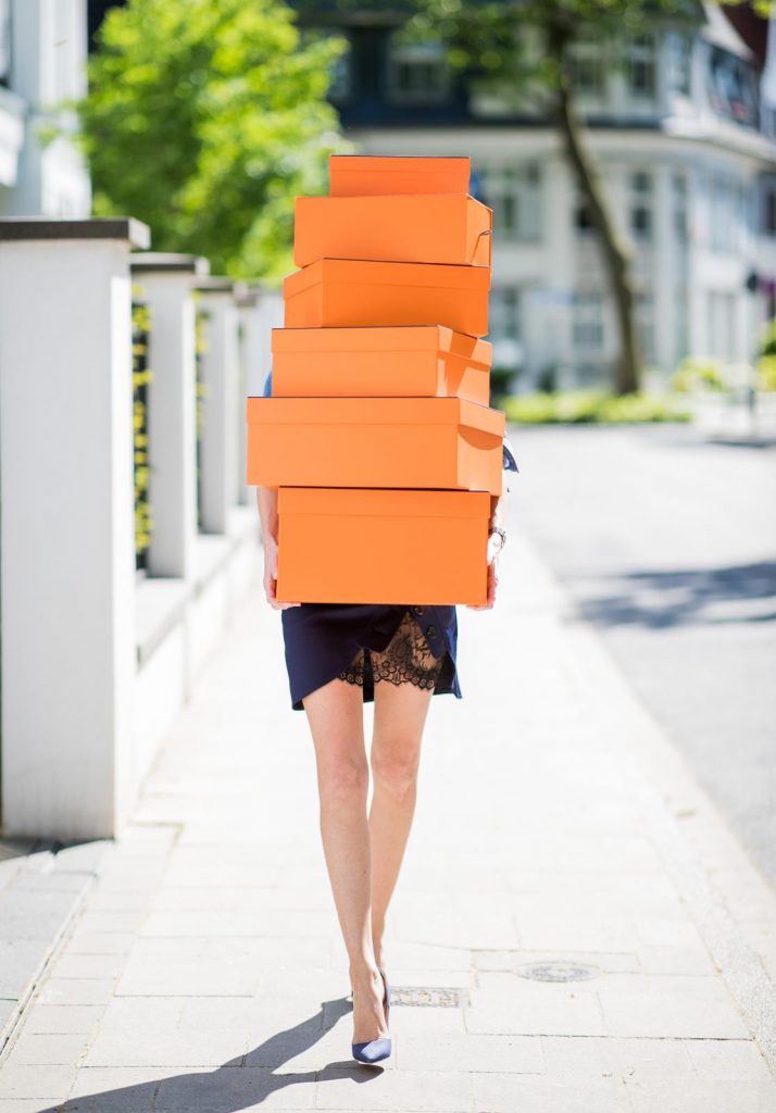 Alexandra Lapp in Hermès Addiction wearing a blue satin skirt with lace by Self-Portrait, a light blue denim shirt by H&M, a purple Kelly bag by Hermès, Denim Jazz Calf So Kate pumps by Christian Louboutin and purple mirrored Aviator sunglasses by Ray Ban on May 5, 2018 in Duesseldorf, Germany.