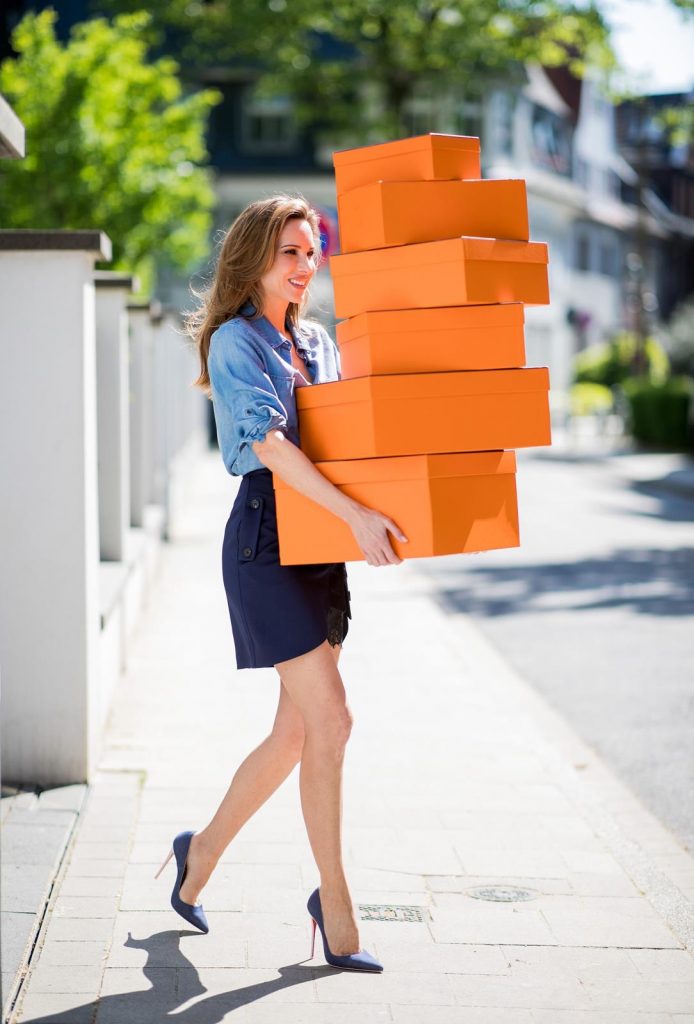 Alexandra Lapp in Hermès Addiction wearing a blue satin skirt with lace by Self-Portrait, a light blue denim shirt by H&M, a purple Kelly bag by Hermès, Denim Jazz Calf So Kate pumps by Christian Louboutin and purple mirrored Aviator sunglasses by Ray Ban on May 5, 2018 in Duesseldorf, Germany.