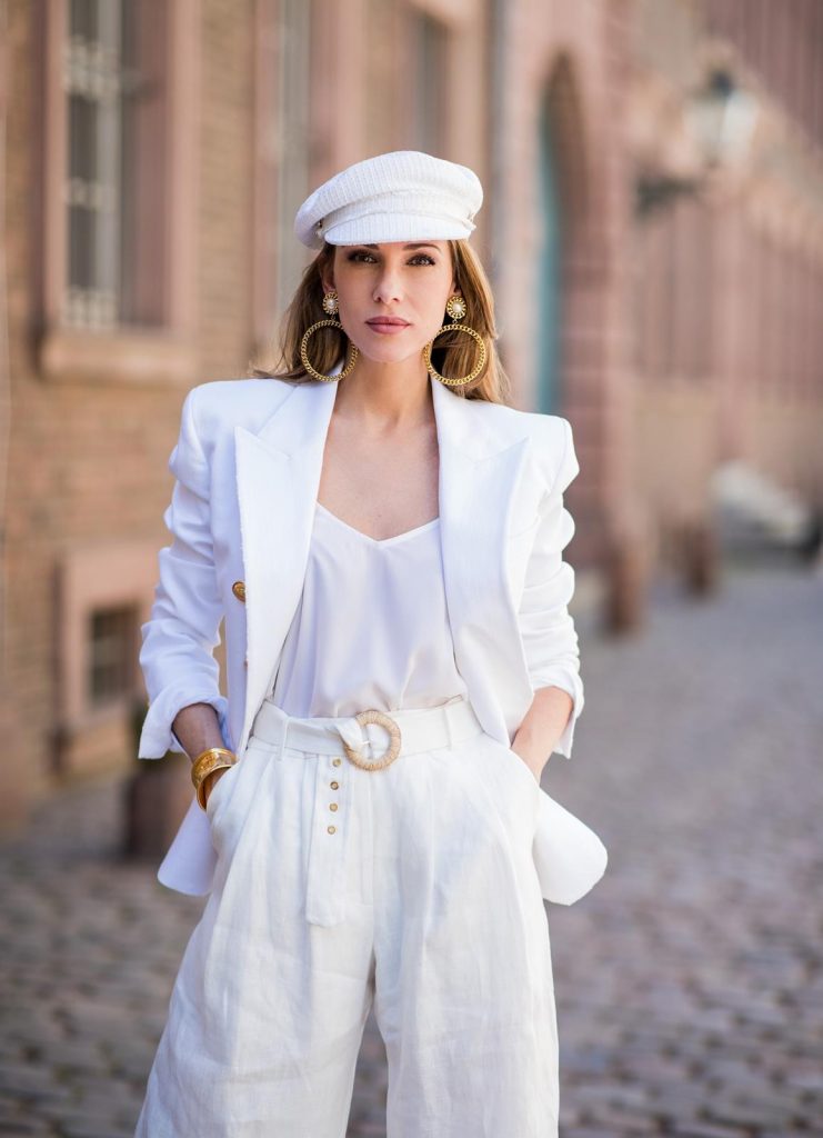 Alexandra Lapp in all white everything wearing a white cotton blazer with gold buttons by Balmain, linen Palazzo pants with a high waist belt in white by Zimmermann, a white Jadicted silk top, white Pigalle Python pumps by Christian Louboutin, vintage Chanel bakerboy cap in white, huge golden hoop earrings with gold framed pearls and a bracelet in gold both vintage from Chanel on May 6, 2018 in Duesseldorf, Germany.