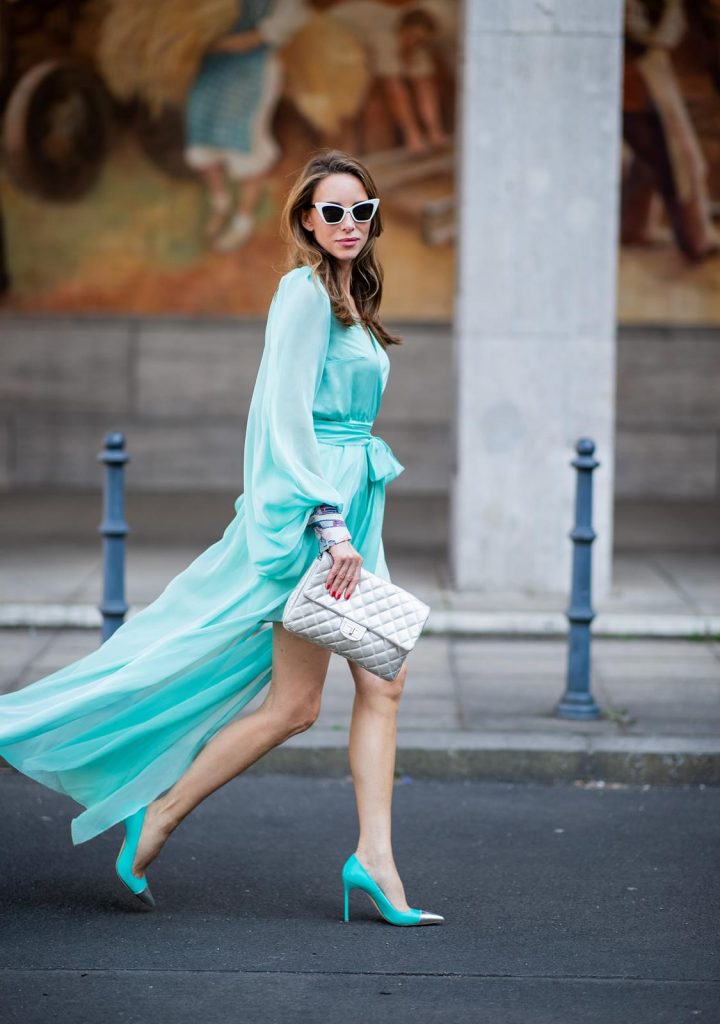 Alexandra Lapp in a turquoise dress wearing a long shine through dress in turquoise by Lana Mueller, a 2.55 silver handbag by Chanel, two tone Manolo Blahnik heels in silver turquoise and white Victoire sunglasses by Saint Laurent seen outside Lana Mueller during the Berlin Fashion Week July 2018 on July 5, 2018 in Berlin, Germany.