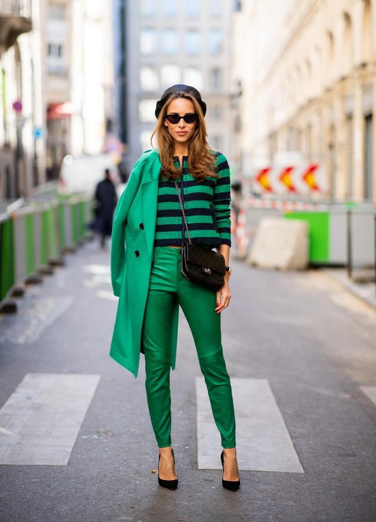 Alexandra Lapp in a Go Green Look wearing green skinny Riani leather pants, black green striped knit with a zipper by Riani, a green oversized blazer jacket by Riani, a black Chanel 2.55 flap bag, black suede Christian Louboutin high heels, cat-eye shaped Isabella Sunglasses by illesteva and a black Eugenia Kim beret during Paris Fashion Week Womenswear Spring/Summer 2019 on September 27, 2018 in Paris, France.