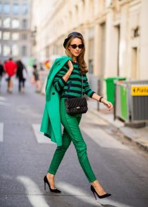 Alexandra Lapp in a Go Green Look wearing green skinny Riani leather pants, black green striped knit with a zipper by Riani, a green oversized blazer jacket by Riani, a black Chanel 2.55 flap bag, black suede Christian Louboutin high heels, cat-eye shaped Isabella Sunglasses by illesteva and a black Eugenia Kim beret during Paris Fashion Week Womenswear Spring/Summer 2019 on September 27, 2018 in Paris, France.