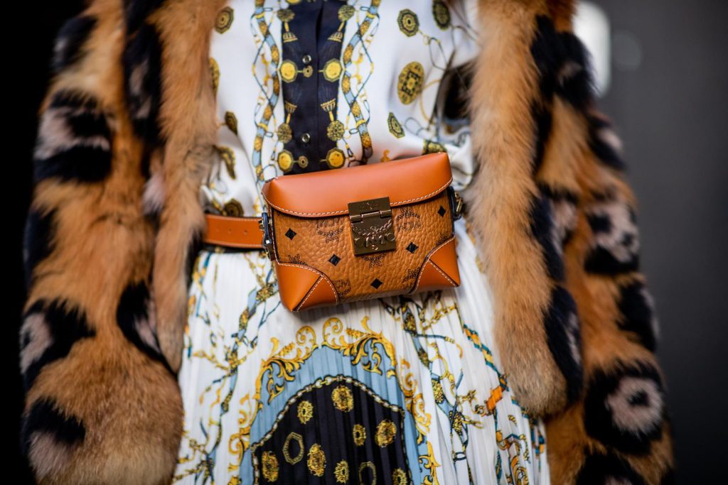 Alexandra Lapp in a Pattern Mix wearing a pleating chain patchwork print skirt and a matching shirt from Zara, a short fur jacket from Yves Salomon with an animal print, Metrisandal open-toe sandals from Christian Louboutin with tape-style straps, the Soft Berlin Belt Bag in Visetos by MCM in cognac and the Gucci cat-eye radiant ivory sunglasses during Paris Fashion Week Womenswear Spring/Summer 2019 on September 24, 2018 in Paris, France.