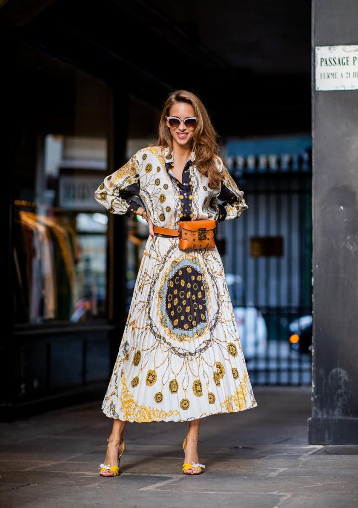 Alexandra Lapp in a Pattern Mix wearing a pleating chain patchwork print skirt and a matching shirt from Zara, a short fur jacket from Yves Salomon with an animal print, Metrisandal open-toe sandals from Christian Louboutin with tape-style straps, the Soft Berlin Belt Bag in Visetos by MCM in cognac and the Gucci cat-eye radiant ivory sunglasses during Paris Fashion Week Womenswear Spring/Summer 2019 on September 24, 2018 in Paris, France.