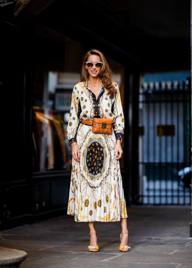 Alexandra Lapp in a Pattern Mix wearing a pleating chain patchwork print skirt and a matching shirt from Zara, a short fur jacket from Yves Salomon with an animal print, Metrisandal open-toe sandals from Christian Louboutin with tape-style straps, the Soft Berlin Belt Bag in Visetos by MCM in cognac and the Gucci cat-eye radiant ivory sunglasses during Paris Fashion Week Womenswear Spring/Summer 2019 on September 24, 2018 in Paris, France.