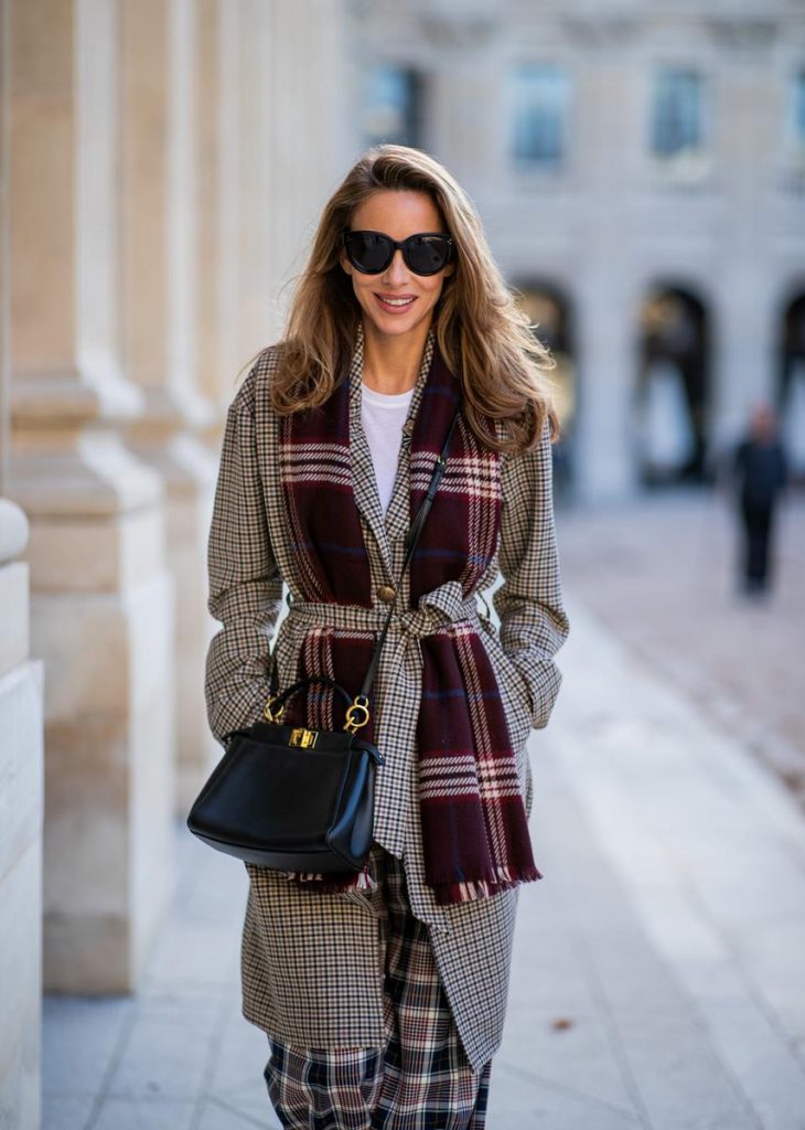 Alexandra Lapp in a Layered Look wearing a plaid oversized coat from SET fashion, a white T-Shirt from Vince, a Glenchek style scarf in dark red tones, wide plaid pants with a long leg in blue and brown tones from Tory Burch, boots in bordeaux from Gianvito Rossi and black Audrey sunglasses from Celine during Paris Fashion Week Womenswear Spring/Summer 2019 on September 27, 2018 in Paris, France.