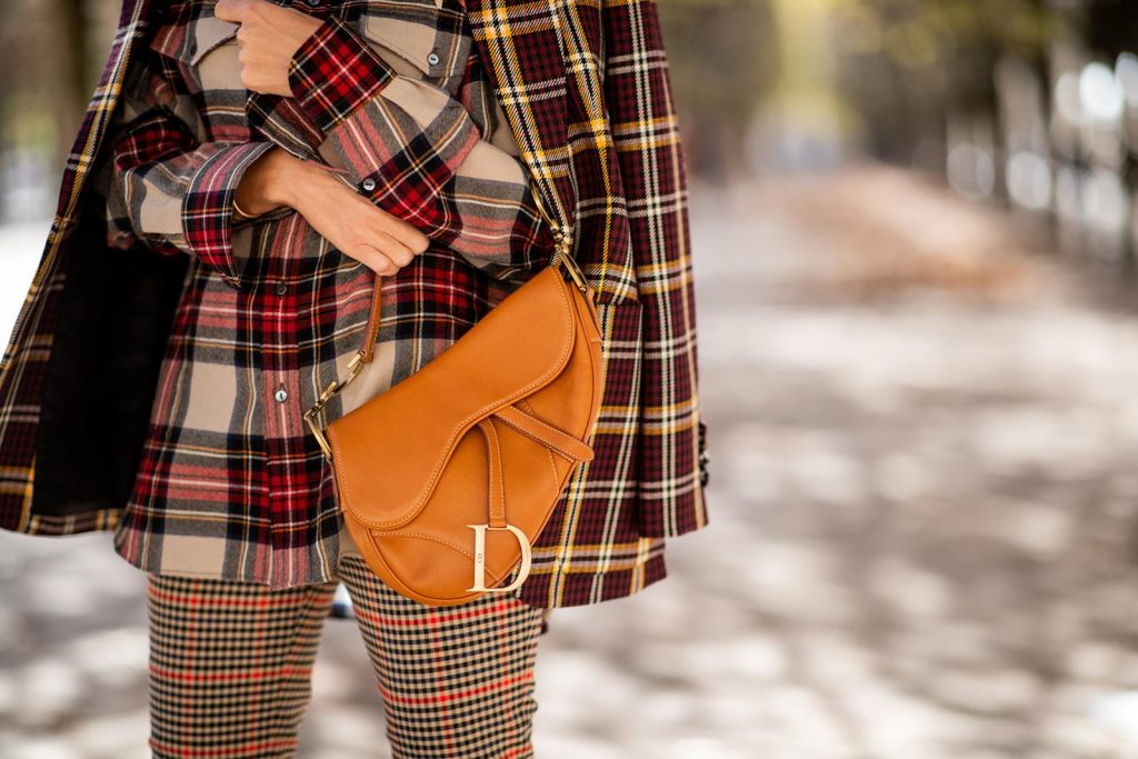 Alexandra Lapp in a Plaid Allover Look is wearing a burgundy and yellow checked wool blazer from Burberry, embroidered checked oversized shirt in red, black, white by Gucci, multi-coloured high-waisted checked trousers from P.A.R.O.S.H., browny embossed leather belt by Max Mara, a vintage Dior saddle bag in cognac, purple Gianvito Rosso boots and black Audrey sunglasses by Celine during Paris Fashion Week Womenswear Spring/Summer 2019 on September 25, 2018 in Paris, France.