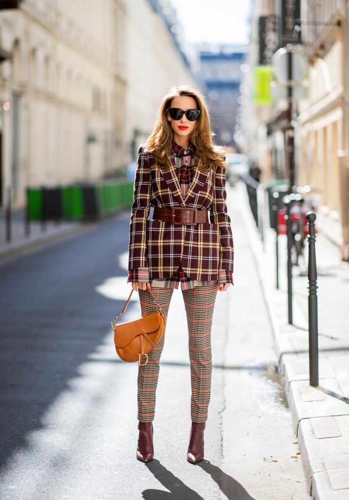 Alexandra Lapp in a Plaid Allover Look is wearing a burgundy and yellow checked wool blazer from Burberry, embroidered checked oversized shirt in red, black, white by Gucci, multi-coloured high-waisted checked trousers from P.A.R.O.S.H., browny embossed leather belt by Max Mara, a vintage Dior saddle bag in cognac, purple Gianvito Rosso boots and black Audrey sunglasses by Celine during Paris Fashion Week Womenswear Spring/Summer 2019 on September 25, 2018 in Paris, France.