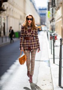 Alexandra Lapp in a Plaid Allover Look is wearing a burgundy and yellow checked wool blazer from Burberry, embroidered checked oversized shirt in red, black, white by Gucci, multi-coloured high-waisted checked trousers from P.A.R.O.S.H., browny embossed leather belt by Max Mara, a vintage Dior saddle bag in cognac, purple Gianvito Rosso boots and black Audrey sunglasses by Celine during Paris Fashion Week Womenswear Spring/Summer 2019 on September 25, 2018 in Paris, France.