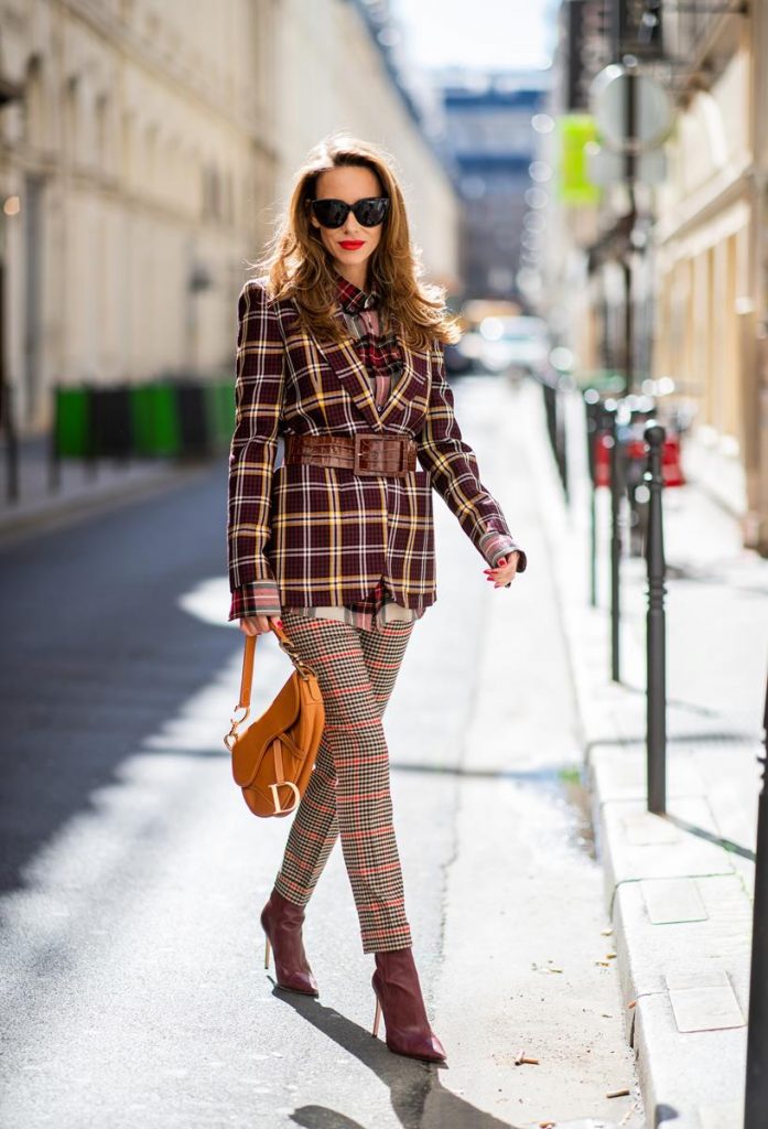 Alexandra Lapp in a Plaid Allover Look is wearing a burgundy and yellow checked wool blazer from Burberry, embroidered checked oversized shirt in red, black, white by Gucci, multi-coloured high-waisted checked trousers from P.A.R.O.S.H., browny embossed leather belt by Max Mara, a vintage Dior saddle bag in cognac, purple Gianvito Rosso boots and black Audrey sunglasses by Celine during Paris Fashion Week Womenswear Spring/Summer 2019 on September 25, 2018 in Paris, France.