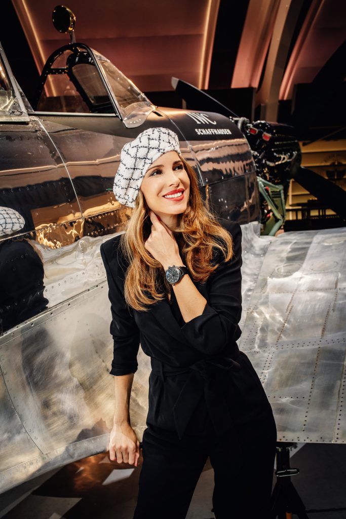 Alexandra Lapp in a Silver Spitfire Look, wearing a IWC Spitfire watch while visiting the IWC Schaffhausen booth at the SIHH 2019 in Geneva.