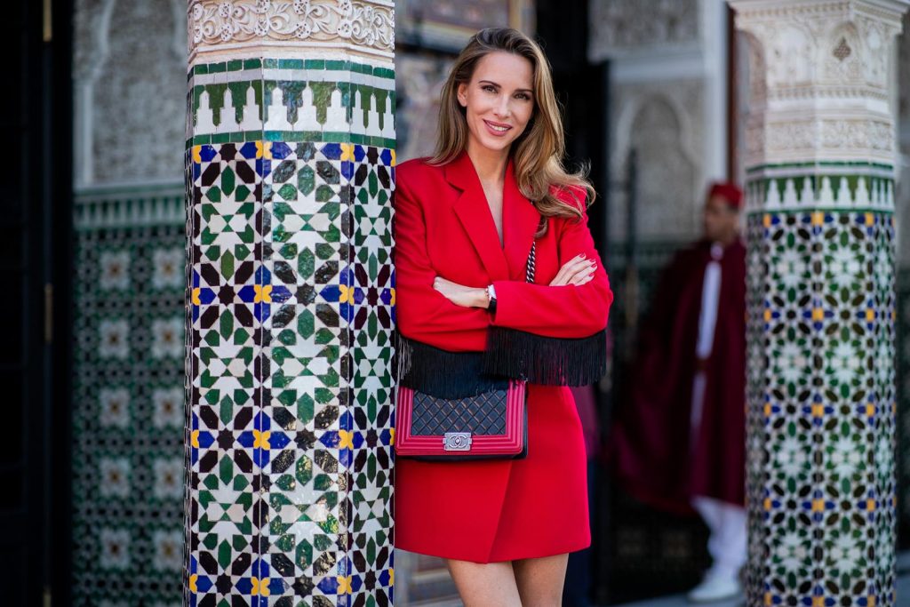 Alexandra Lapp in a red Blazer dress look wearing a red blazer dress with fringes at both arms from Pearl and Rubies, black Cowboy boots with a silver tip from Isabel Marant, red and black boy bag from Chanel and oversized sunglasses from Chloe on November 25, 2018 in Marrakech, Morocco. (Photo by Christian Vierig/Getty Images)