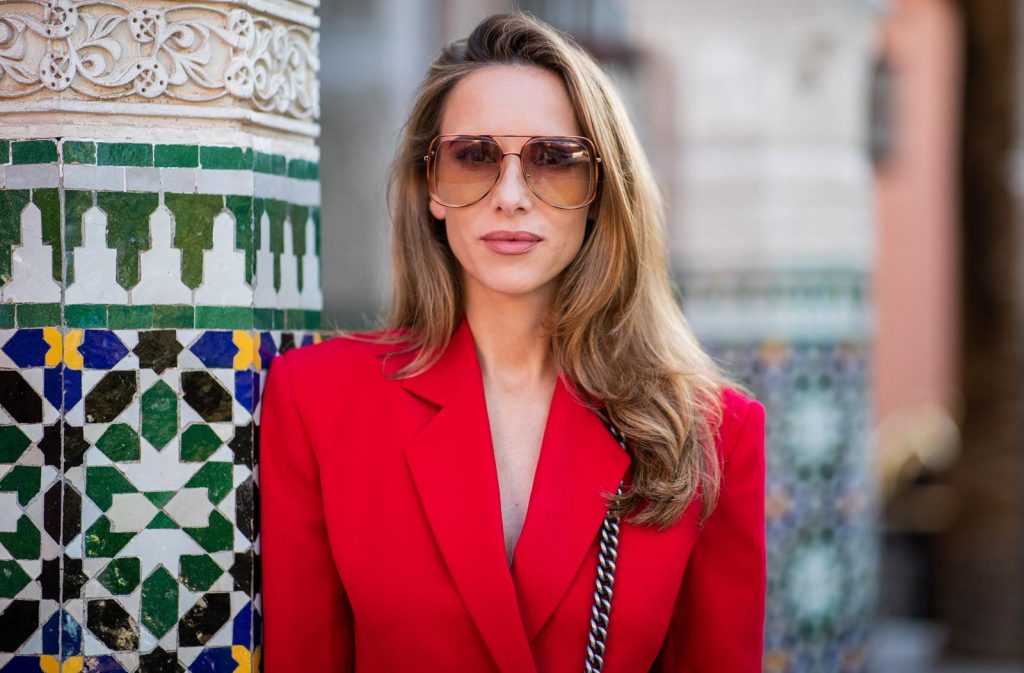 Alexandra Lapp in a red Blazer dress look wearing a red blazer dress with fringes at both arms from Pearl and Rubies, black Cowboy boots with a silver tip from Isabel Marant, red and black boy bag from Chanel and oversized sunglasses from Chloe on November 25, 2018 in Marrakech, Morocco. (Photo by Christian Vierig/Getty Images)