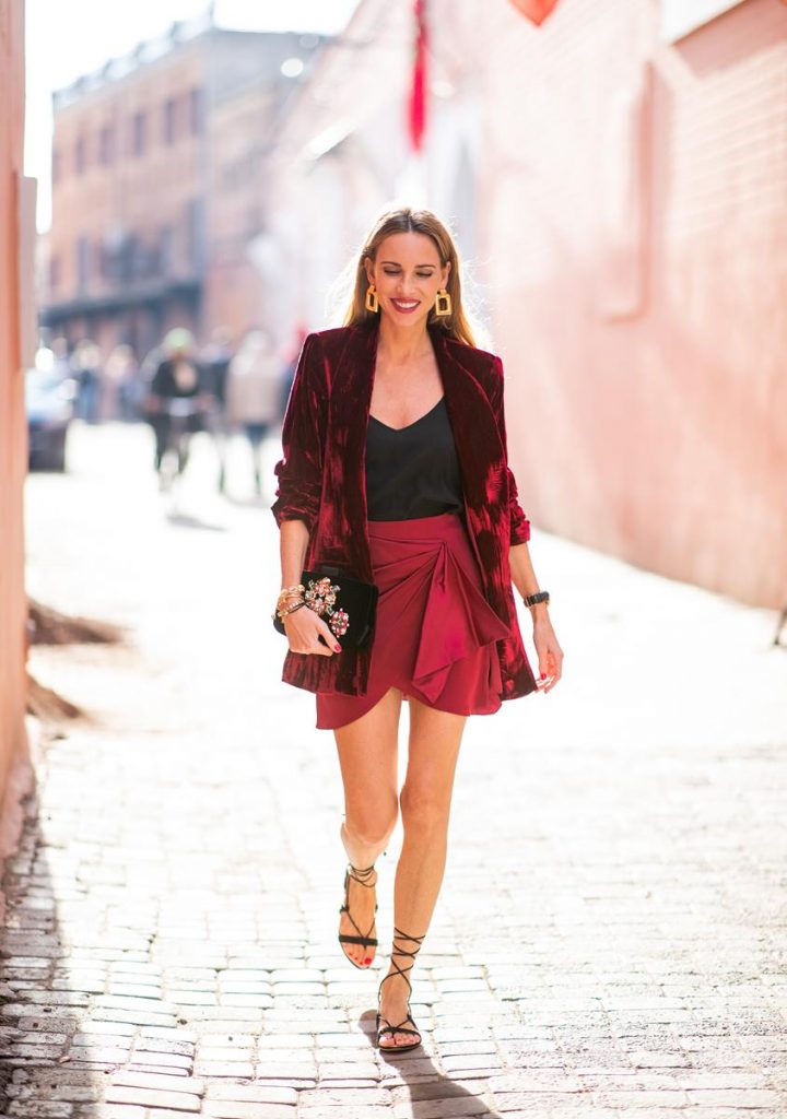 Alexandra Lapp in a wrap skirt look wearing a loose fit crushed velvet red blazer from Alice + Olivia, a black top from Jadicted, a satin red mini skirt with a rap-effect from Caroline Constas, a black velvet handbag with sparkling stones and pearls from Roger Vivier, black woven Sienna sandals from Cult Gaia, gold earrings from Zara on November 26, 2018 in Marrakech, Morocco. (Photo by Christian Vierig/Getty Images)