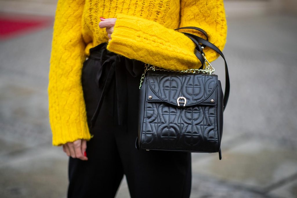 Alexandra Lapp in a Diadora Backpack look, wearing a cropped yellow cable knit sweater from R13 with paperbag pants from H&M, Gianvito Rossi patent leather pumps, Zara earrings and a H&M statement necklace and Aigner Diadora M backpack in during the Berlin Fashion Week Autumn/Winter 2019 on January 17, 2019 in Berlin, Germany. (Photo by Christian Vierig/Getty Images)