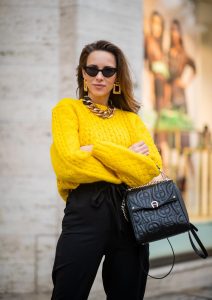 Alexandra Lapp in a Diadora Backpack look, wearing a cropped yellow cable knit sweater from R13 with paperbag pants from H&M, Gianvito Rossi patent leather pumps, Zara earrings and a H&M statement necklace and Aigner Diadora M backpack in during the Berlin Fashion Week Autumn/Winter 2019 on January 17, 2019 in Berlin, Germany. (Photo by Christian Vierig/Getty Images)