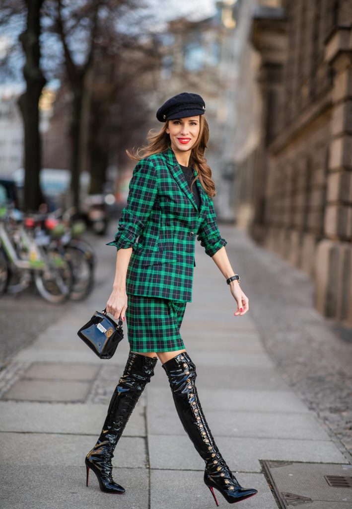 Alexandra Lapp in a checkered suit look, wearing a feminine green checkered Riani blazer with a matching pleated skirt, styled with a Vince knitted T-shirt, a black Chanel tweed baker boy cap, patent leather Louise over-the-knee boots from Christian Louboutin, and a ZAC Zac Posen patent Mini 'Eartha Iconic‘ bag during the Berlin Fashion Week Autumn/Winter 2019 on January 18, 2019 in Berlin, Germany. (Photo by Christian Vierig/Getty Images)