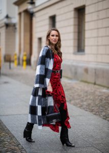 Alexandra Lapp in a Red Animal Print Look, wearing the long Adriana animal print dress from Rixo, a black and white wool coat from Ganni, the Isabel Marant Lamsy cowboy boots, a black boy bag from Chanel, a silver buckled H&M cowboy belt, a western cowboy necklace and red cat-eyed sunglasses by Celine during the Berlin Fashion Week Autumn/Winter 2019 on January 15, 2019 in Berlin, Germany. (Photo by Christian Vierig/Getty Images)