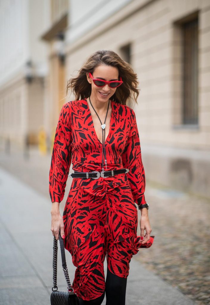  Alexandra Lapp in a Red Animal Print Look, wearing the long Adriana animal print dress from Rixo, a black and white wool coat from Ganni, the Isabel Marant Lamsy cowboy boots, a black boy bag from Chanel, a silver buckled H&M cowboy belt, a western cowboy necklace and red cat-eyed sunglasses by Celine during the Berlin Fashion Week Autumn/Winter 2019 on January 15, 2019 in Berlin, Germany. (Photo by Christian Vierig/Getty Images)
