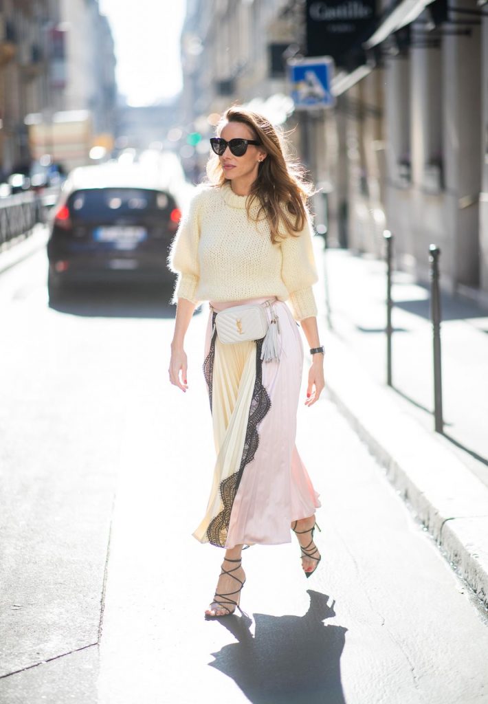 Alexandra Lapp in a Fashion Double look, wearing a chunky knit sweater from Ganni, a multi colored Self-Portrait plissée-skirt, Saint Laurent Blanc Vi belt bag, black Gianvito Rossi sandals and Céline Audrey sunglasses and Isabel Lapp is seen wearing a Sandro suit with double breasted blazer in light pink and matching high waisted pants, Saint Laurent mini bag, Isabel Marant heels and Céline Shadow sunglasses, all by Breuninger, seen during Paris Fashion Week Womenswear Fall/Winter 2019/2020 on February 27, 2019 in Paris, France. (Photo by Christian Vierig/Getty Images)