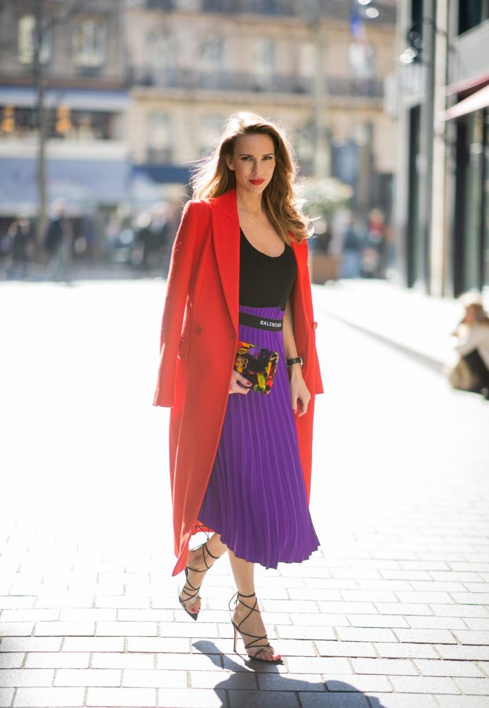 Alexandra Lapp in a Color Flash look, wearing a red Givenchy long coat, a purple Balenciaga plissée skirt, Off-white stretch top, pointed Gianvito Rossi sandals in black, Balenciaga BB printed velvet clutch all from Breuninger during Paris Fashion Week Womenswear Fall/Winter 2019/2020 on February 26, 2019 in Paris, France. (Photo by Christian Vierig/Getty Images)