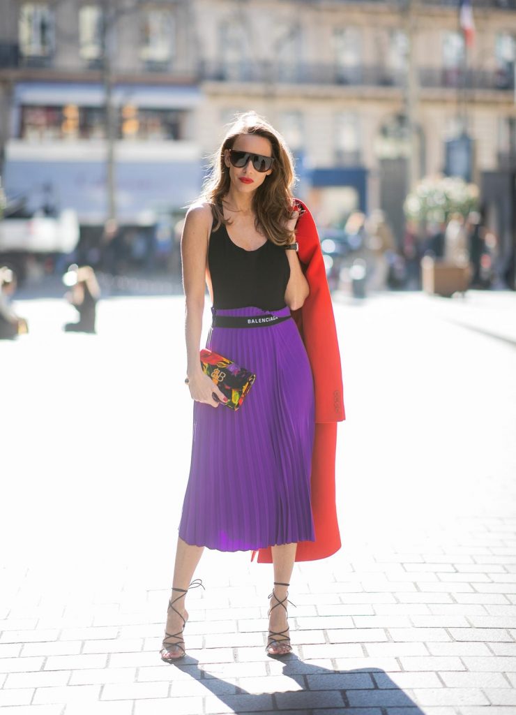 Alexandra Lapp in a Color Flash look, wearing a red Givenchy long coat, a purple Balenciaga plissée skirt, Off-white stretch top, pointed Gianvito Rossi sandals in black, Balenciaga BB printed velvet clutch all from Breuninger during Paris Fashion Week Womenswear Fall/Winter 2019/2020 on February 26, 2019 in Paris, France. (Photo by Christian Vierig/Getty Images)