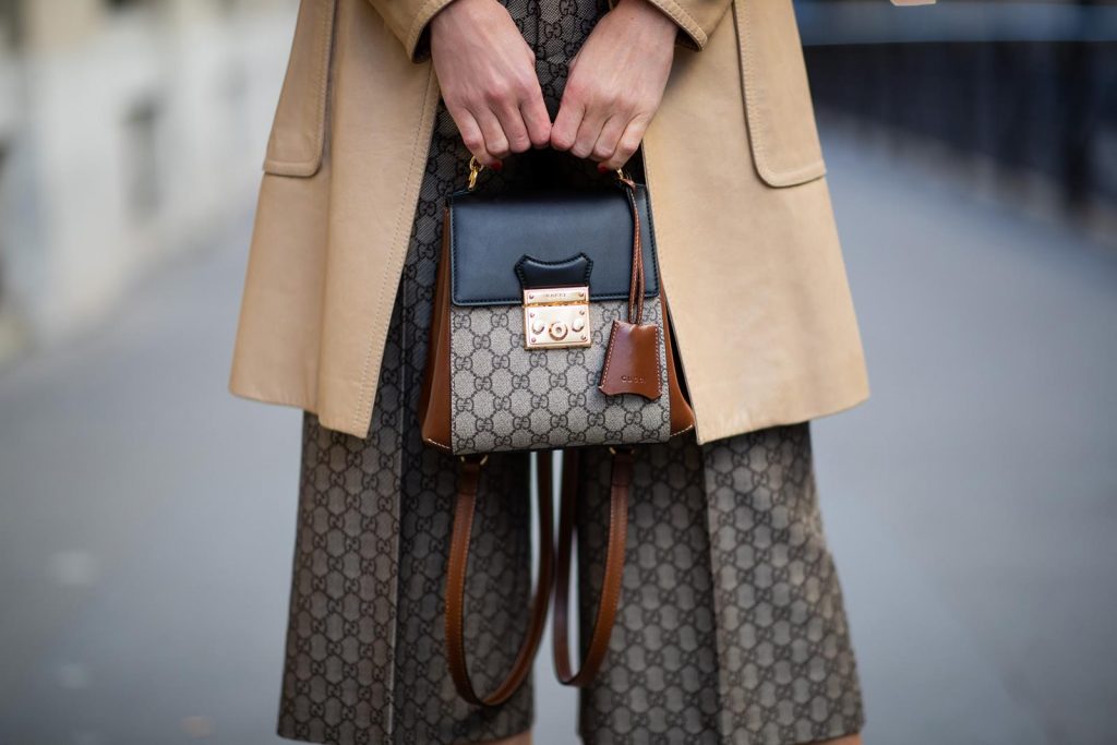 Alexandra Lapp in a Gucci culotte pants look, wearing the Culottes with monogram pattern, brown and black Gucci backpack with monogram pattern, a sparkling white swimsuit with the Gucci logo print, vintage leather Trenchcoat from Gucci, So Kate Christian Louboutin heels in cognac during Paris Fashion Week Womenswear Fall/Winter 2019/2020 on February 25, 2019 in Paris, France. (Photo by Christian Vierig/Getty Images)