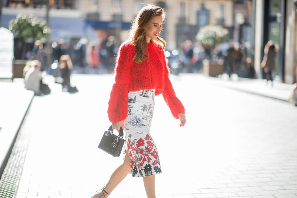 Alexandra Lapp in a Printed Skirt look, wearing a fitted two button coat in bright red from Givenchy, with a NO.21 sequined twill pencil skirt with a Palm-print, a red wool loose knit sweater from Ganni - all from Breuninger, black sandals from Gianvito Rossi, Prada cat-eye shaped sunglasses with red details and the Lady Dior mini bag during Paris Fashion Week Womenswear Fall/Winter 2019/2020 on February 26, 2019 in Paris, France. (Photo by Christian Vierig/Getty Images)