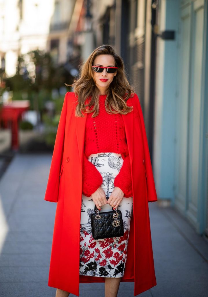 Alexandra Lapp in a Printed Skirt look, wearing a fitted two button coat in bright red from Givenchy, with a NO.21 sequined twill pencil skirt with a Palm-print, a red wool loose knit sweater from Ganni - all from Breuninger, black sandals from Gianvito Rossi, Prada cat-eye shaped sunglasses with red details and the Lady Dior mini bag during Paris Fashion Week Womenswear Fall/Winter 2019/2020 on February 26, 2019 in Paris, France. (Photo by Christian Vierig/Getty Images)