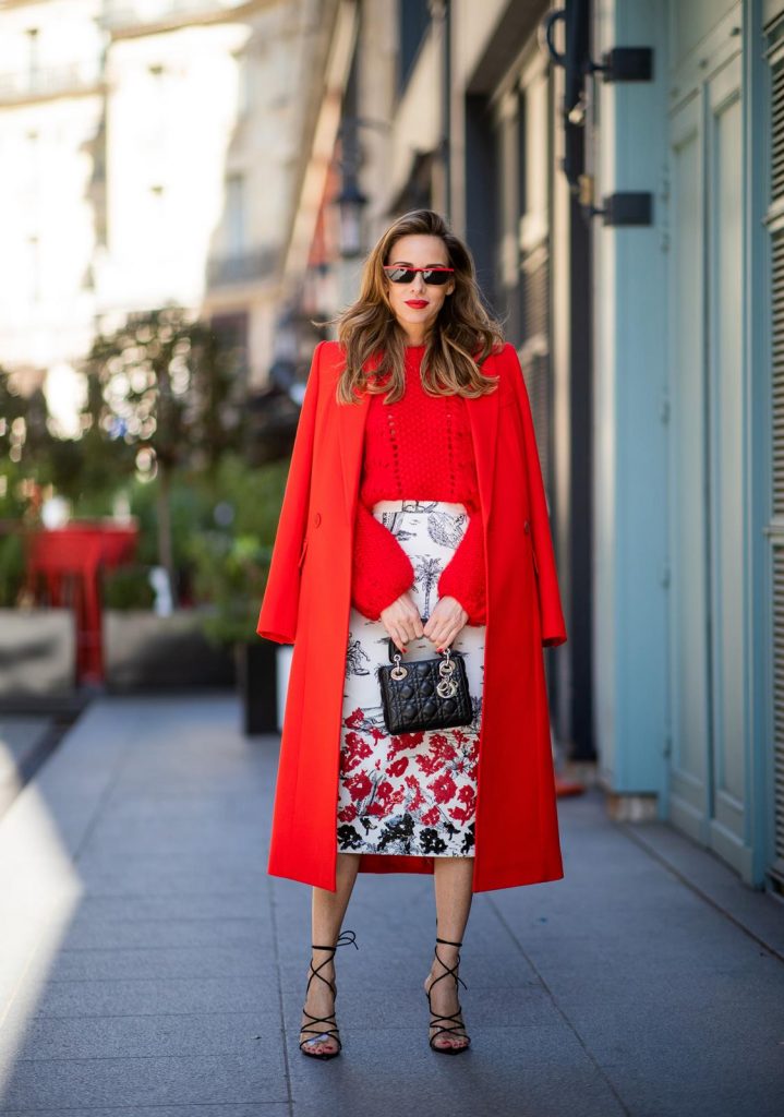 Alexandra Lapp in a Printed Skirt look, wearing a fitted two button coat in bright red from Givenchy, with a NO.21 sequined twill pencil skirt with a Palm-print, a red wool loose knit sweater from Ganni - all from Breuninger, black sandals from Gianvito Rossi, Prada cat-eye shaped sunglasses with red details and the Lady Dior mini bag during Paris Fashion Week Womenswear Fall/Winter 2019/2020 on February 26, 2019 in Paris, France. (Photo by Christian Vierig/Getty Images)