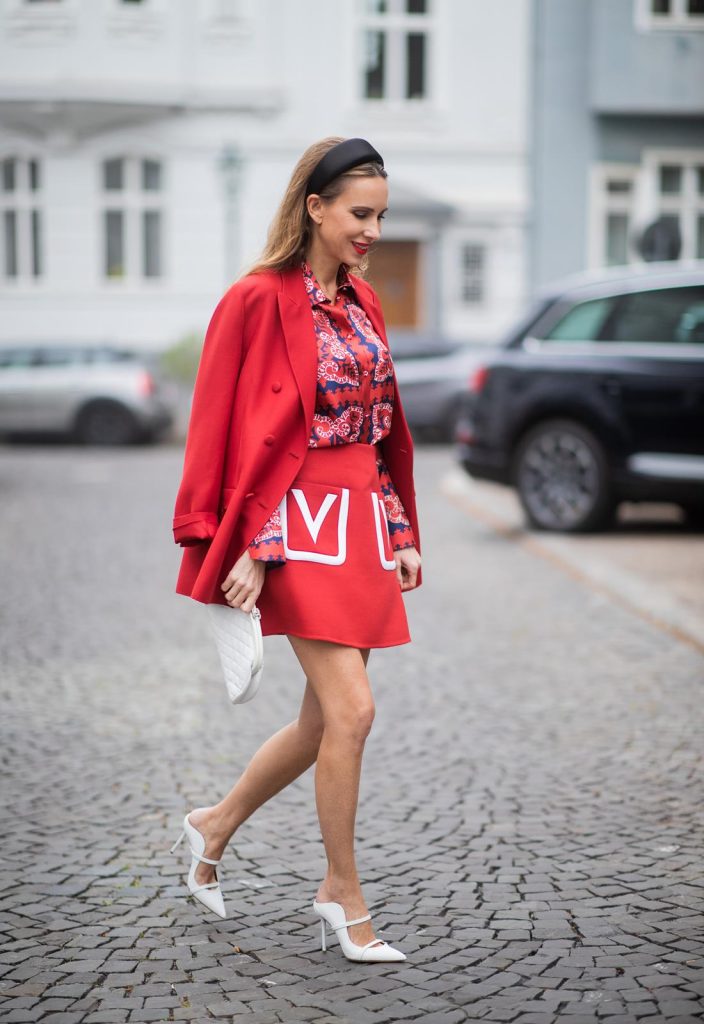 Alexandra Lapp in a Valentino Look, wearing a short red wool skirt with the embroidered V Logo, with a matching long oversized blazer, a logo printed twill shirt in blue white and red- all from Valentino, a black silk satin headband from Prada on May 01, 2019 in Duesseldorf, Germany. (Photo by Christian Vierig/Getty Images)