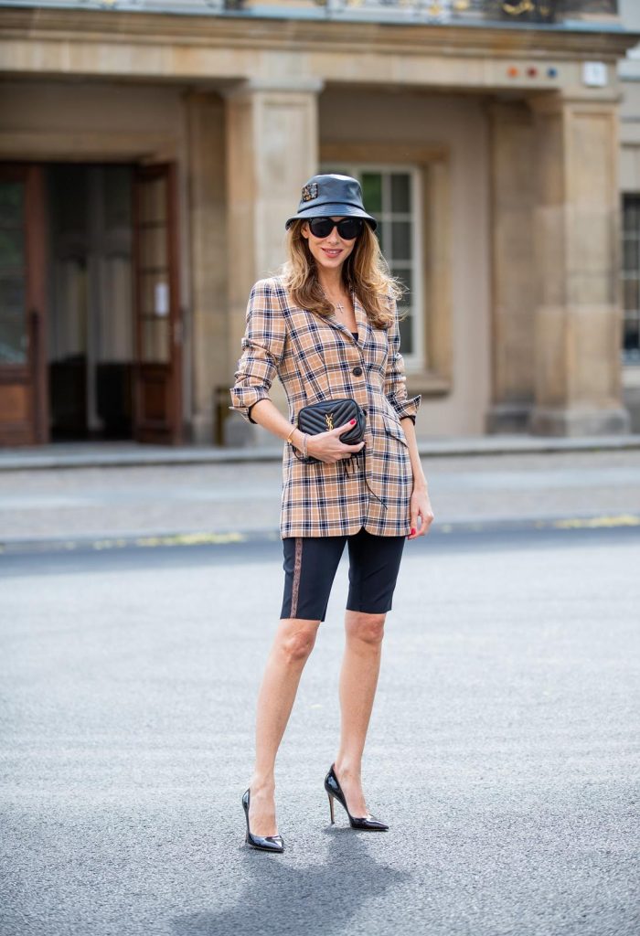 Alexandra Lapp is seen wearing a beige brown checkered blazer, black cycling pants and black bucket hat from Riani, Céline Audrey sunglasses, black St. Laurent Lou belt bag and black Gianvito Rossi patent leather pumps during Berlin Fashion Week on July 02, 2019 in Berlin, Germany. (Photo by Christian Vierig/Getty Images)