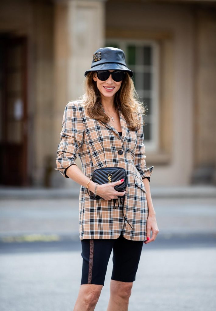 Alexandra Lapp is seen wearing a beige brown checkered blazer, black cycling pants and black bucket hat from Riani, Céline Audrey sunglasses, black St. Laurent Lou belt bag and black Gianvito Rossi patent leather pumps during Berlin Fashion Week on July 02, 2019 in Berlin, Germany. (Photo by Christian Vierig/Getty Images)