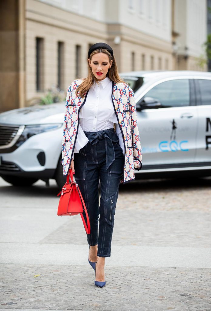 Alexandra Lapp in a Women and Technology look, is seen wearing a IWC Portofino Chronograph in front of a Mercedes EQC during MBFW Berlin.