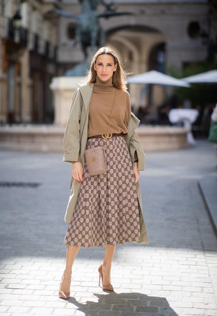 PARIS, FRANCE - SEPTEMBER 23:Blogger, Model and Influencer Alexandra Lapp is seen wearing a Gucci GG pleated jersey midi skirt, GG Marmont Mini-Bucket bag in nude, Christian Louboutin So Kate pumps in camel, camel Nili Lotan sweater, beige Zara trenchcoat during Paris Fashion Week Womenswear Spring Summer 2020 on September 23, 2019 in Paris, France. 