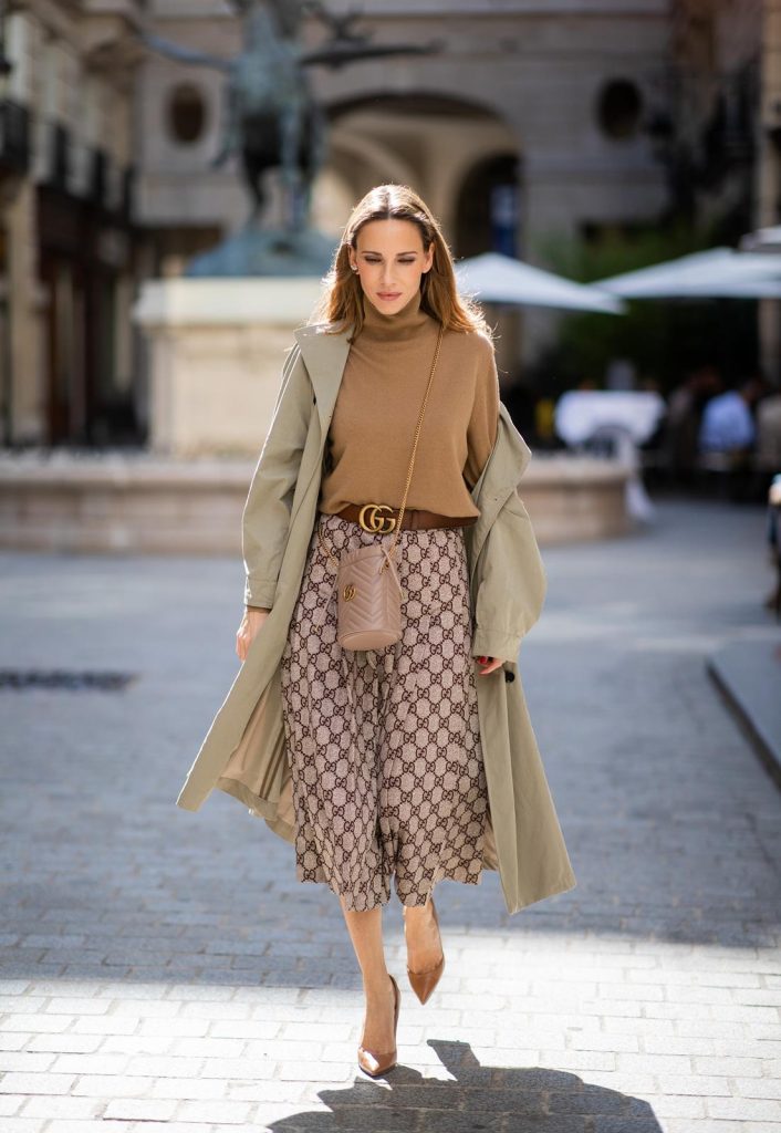 PARIS, FRANCE - SEPTEMBER 23:Blogger, Model and Influencer Alexandra Lapp is seen wearing a Gucci GG pleated jersey midi skirt, GG Marmont Mini-Bucket bag in nude, Christian Louboutin So Kate pumps in camel, camel Nili Lotan sweater, beige Zara trenchcoat during Paris Fashion Week Womenswear Spring Summer 2020 on September 23, 2019 in Paris, France. 