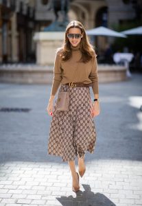PARIS, FRANCE - SEPTEMBER 23:Blogger, Model and Influencer Alexandra Lapp is seen wearing a Gucci GG pleated jersey midi skirt, GG Marmont Mini-Bucket bag in nude, Christian Louboutin So Kate pumps in camel, camel Nili Lotan sweater, beige Zara trenchcoat during Paris Fashion Week Womenswear Spring Summer 2020 on September 23, 2019 in Paris, France.