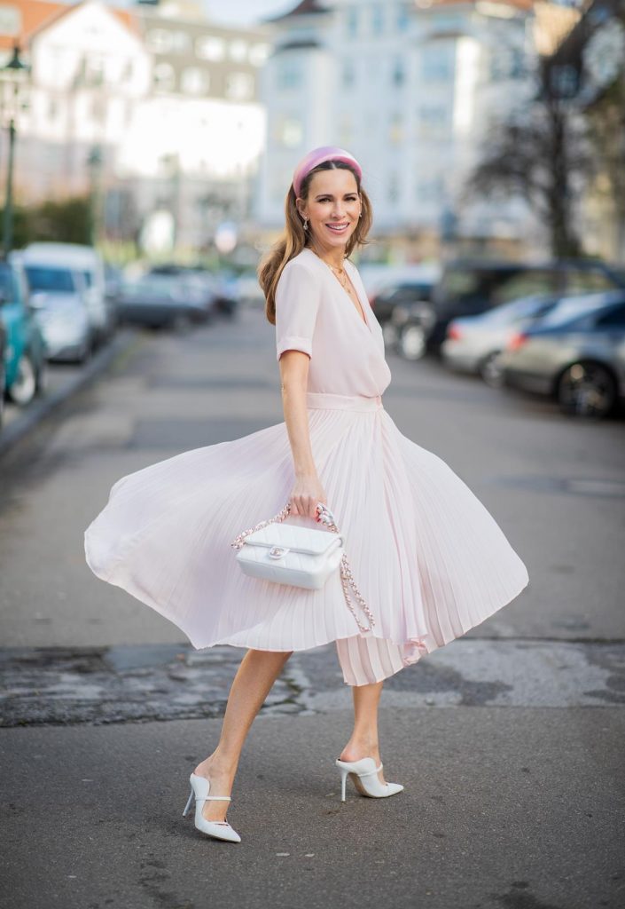 DUESSELDORF, GERMANY : Alexandra Lapp is seen wearing a monochrome look Riani, pink pleated dress, pink oversized blazer, white Chanel bag on December 11, 2019 in Duesseldorf, Germany. (Photo by Christian Vierig/Getty Images)