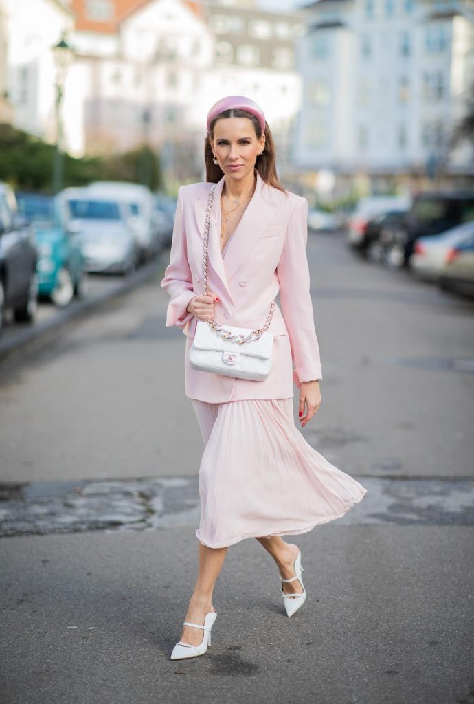 DUESSELDORF, GERMANY : Alexandra Lapp is seen wearing a monochrome look Riani, pink pleated dress, pink oversized blazer, white Chanel bag on December 11, 2019 in Duesseldorf, Germany. (Photo by Christian Vierig/Getty Images)